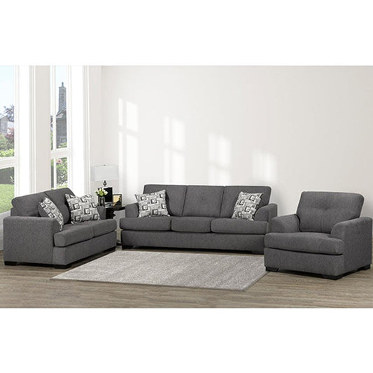 Gray sectional sofa with patterned cushions in a living room setting.
