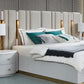 Modern bedroom with a bed, nightstands, and lamps.