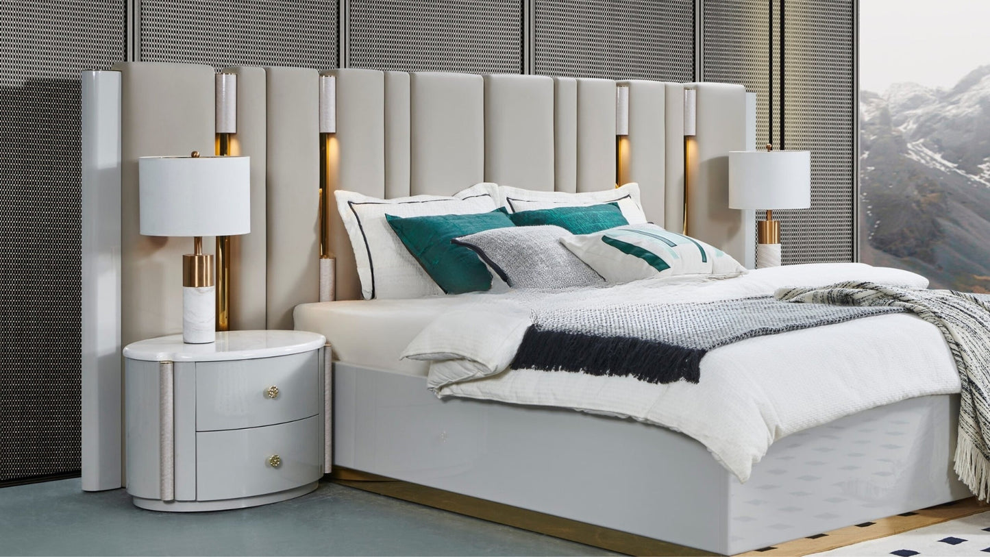 Modern bedroom with a bed, nightstands, and lamps.