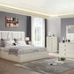 Modern bedroom with white furniture set against a gray wall.