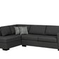Black sectional sofa with a patterned pillow on a white background