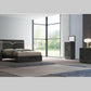 Modern bedroom with dark wood furniture including a bed, dresser, and nightstands.