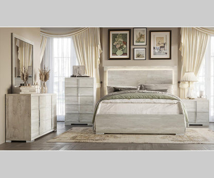 Modern bedroom set with bed, dresser, and nightstands in a well-lit room.