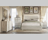 Modern bedroom set with bed, dresser, and nightstands in a well-lit room.