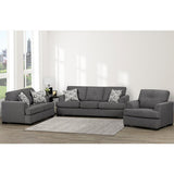 Gray sectional sofa with patterned cushions in a living room setting.