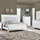 White bedroom furniture set with mirror accents in a room with gray walls and a patterned rug.