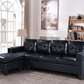 Black leather sectional sofa in a living room setting with decor elements.