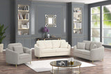 Modern living room with white sofa, armchair, and coffee table in a stylishly decorated room.