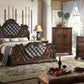 Luxurious bedroom set with dark wood furniture, including bed, dresser, and mirror.