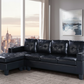 Black leather sectional sofa in a living room with large windows and cityscape view.