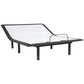 Black adjustable bed frame with glass top on a white background