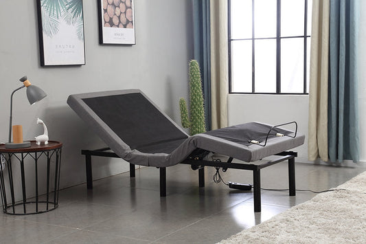 Gray adjustable bed in a room with a window and decor